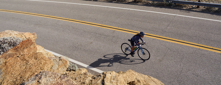 road cyclist riding up mountain road