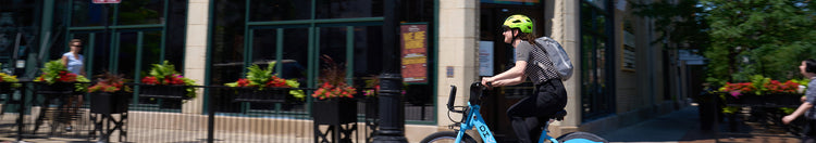 cyclist riding bike through city.