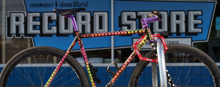 bike locked up with folding lock in front of record store