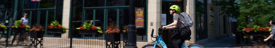 cyclist riding bike through city.  