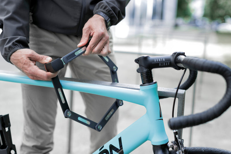 Load image into Gallery viewer, person locking blue bike to rack with ABUS Bordo 5700 #size_80cm

