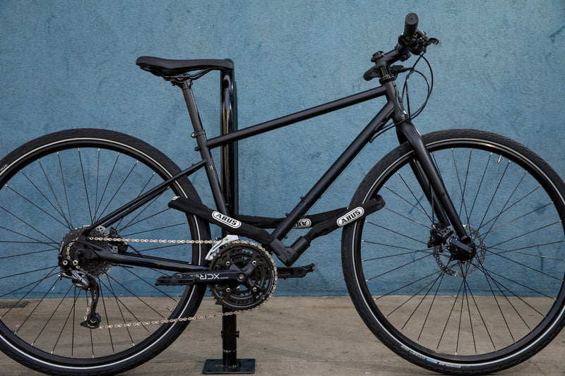 Load image into Gallery viewer, black bike locked with 1010 chain
