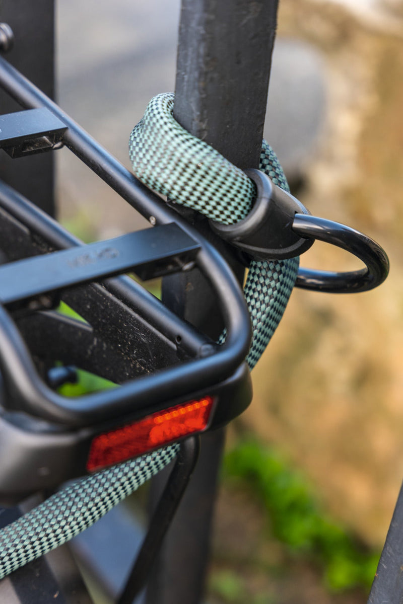 Load image into Gallery viewer, Slow green ABUS Infinity loop wrapped around railing to secure bicycle  #color_Slow Green
