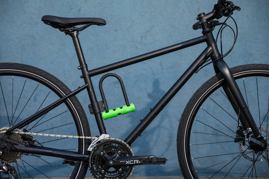 Black bike with ABUS 410 Mini Long Shackle attached to bracket.