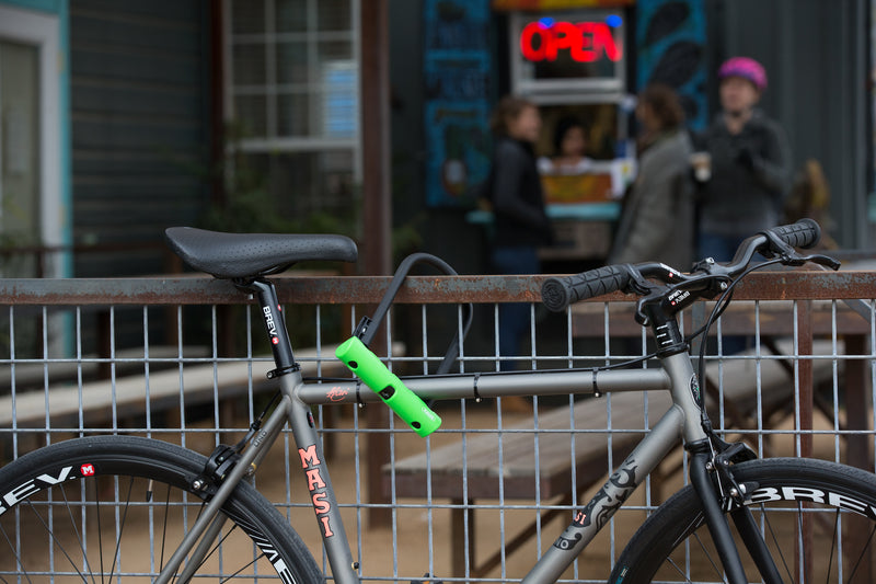 Load image into Gallery viewer, Bicycle secured to fence outside coffee shop with green ABUS Ultra 410 #size_230mm
