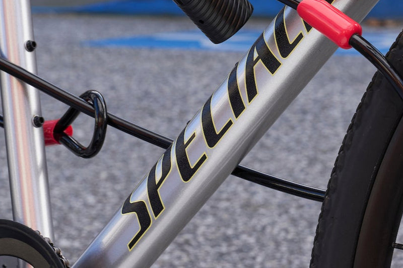 Load image into Gallery viewer, Silver bicycle with a red lock against a blurred indoor background #size_140mm
