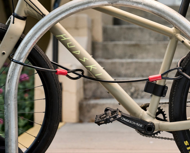 Load image into Gallery viewer, Beige bicycle locked to a metal pole with a building in the background #size_230mm
