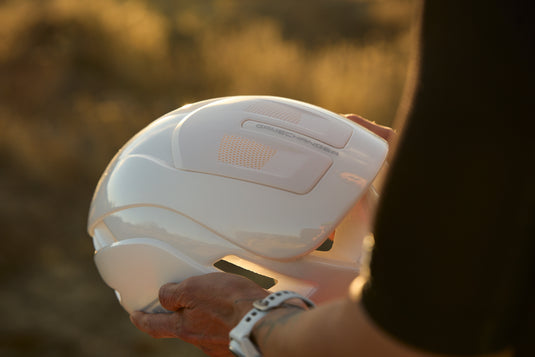 cyclist holding white ABUS GameChanger 2.0 Pure helmet