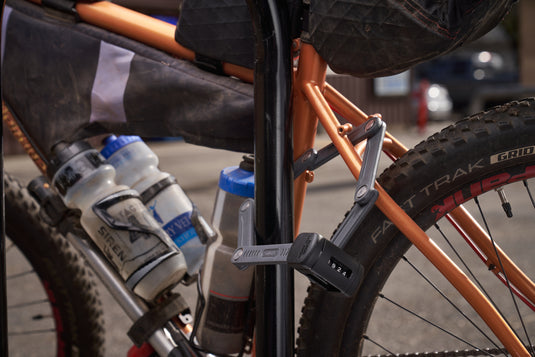 ABUS Bordo 6055C securing orange bicycle to rack #size_60cm