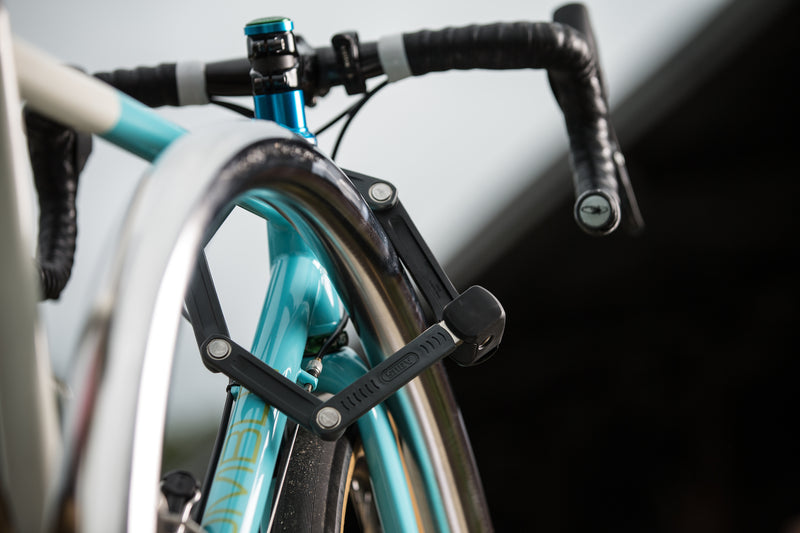 Load image into Gallery viewer, Black ABUS Bordo 6055K securing blue bicycle to bike rack #color_black
