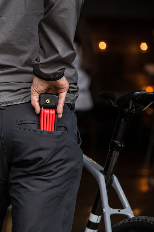 cyclist pulling ABUS Bordo 6055 mini from rear pocket