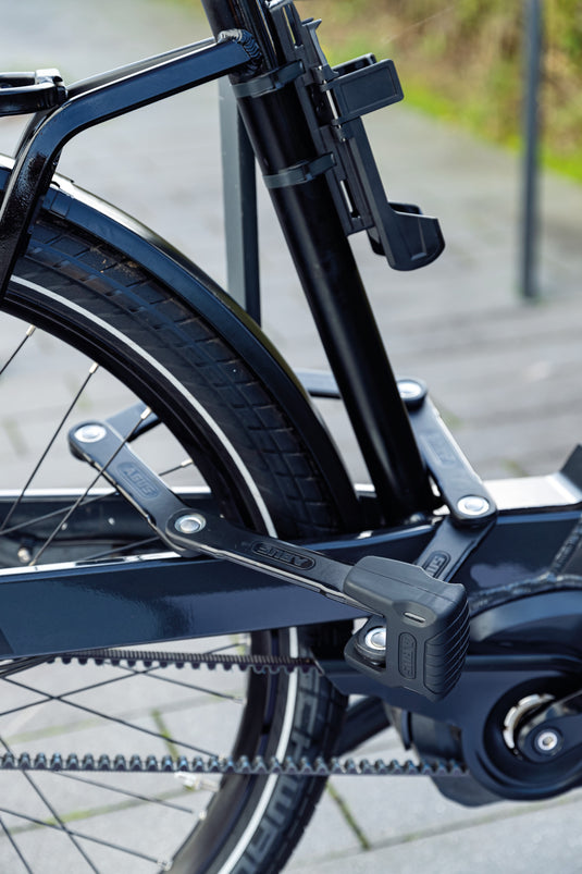ABUS Bordo XPlus 6500 securing e-bike to rack through rear wheel