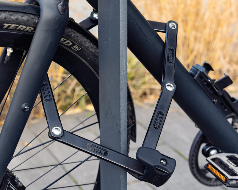 Load image into Gallery viewer, ABUS Bordo 6000K folding lock securing black bicycle to bike rack #size_90cm
