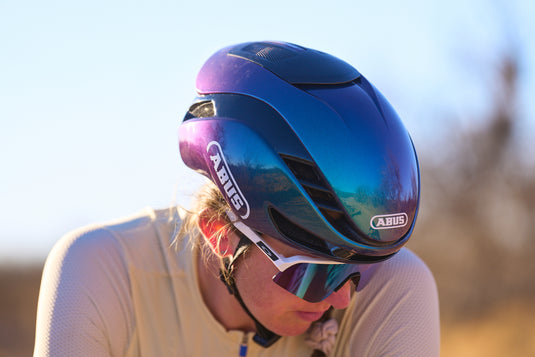 close-up detail shot of cyclst earing purple ABUS GameChanger 2.0 helmet