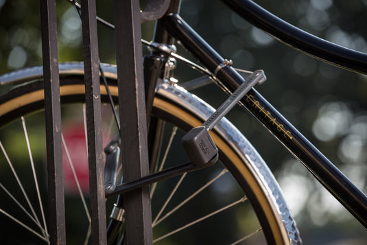 ABUS Bordo 6055 securing black bicycle to bike rack