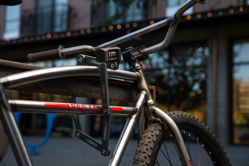 Load image into Gallery viewer, silver BMX cruiser secured to rack in urban environment with ABUS Bordo 5700C #color_black
