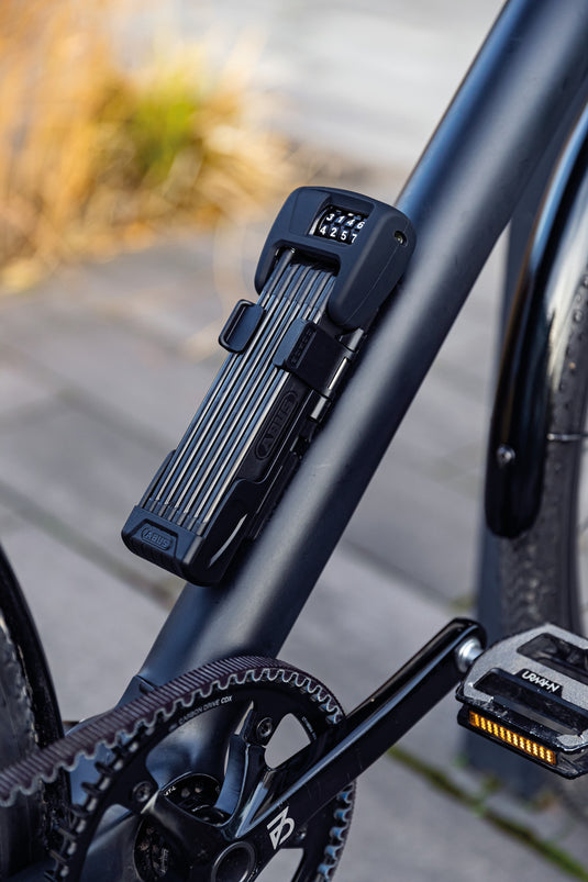 ABUS Bordo 6000C in bracket attached to black bike.