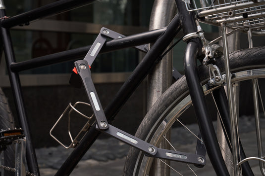 black bicycle secured to rack with ABUS Bordo 5700