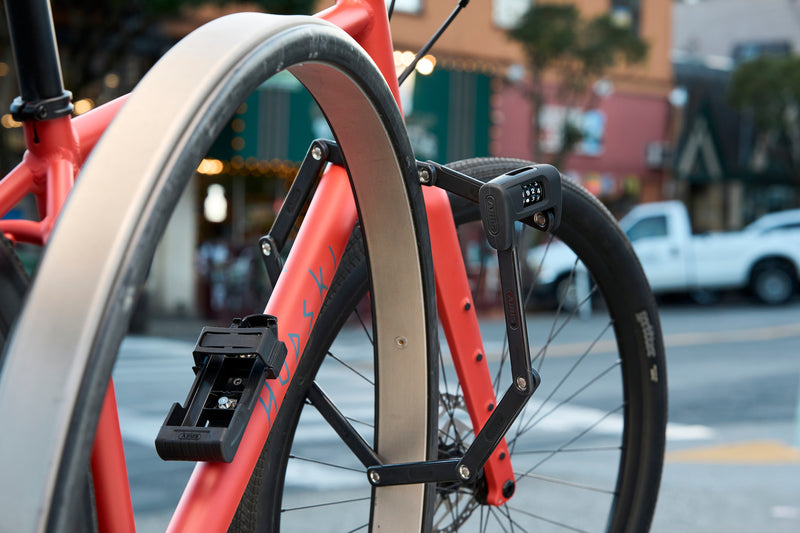 Load image into Gallery viewer, ABUS Bordo 6000C securing orange bike to rack #size_120cm
