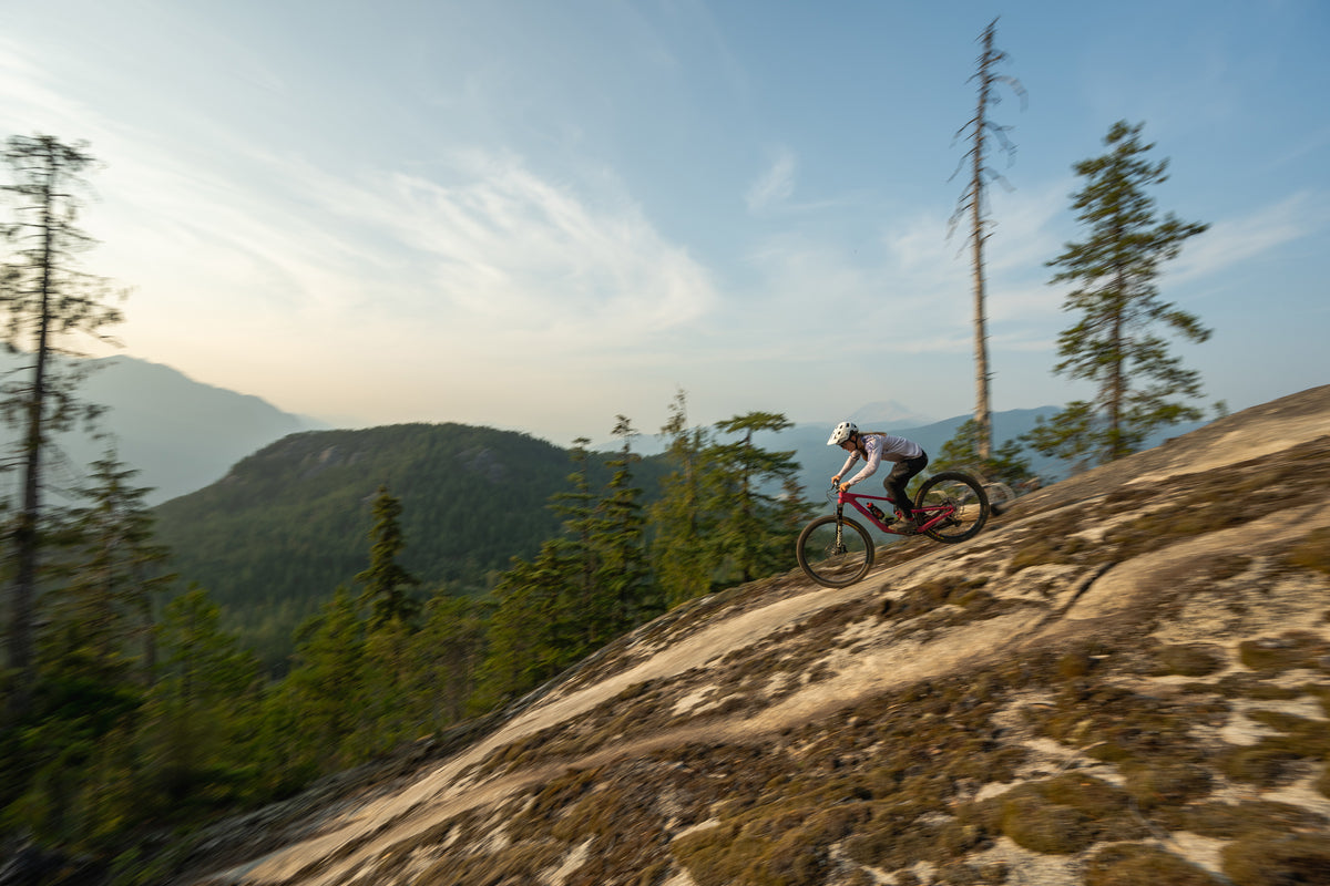 image of cyclst riding steep trail in mountians.