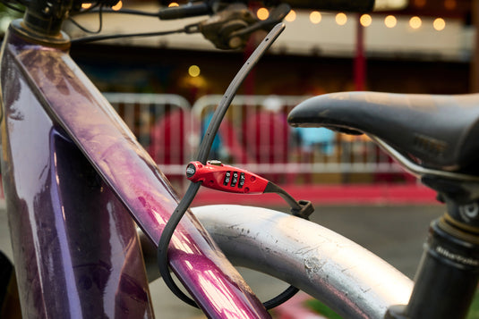 Purple bicycle secured with Combiflex travelGaurd in red