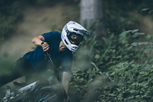 Cyclist riding trails wearing white ABUS HiDrop helmet