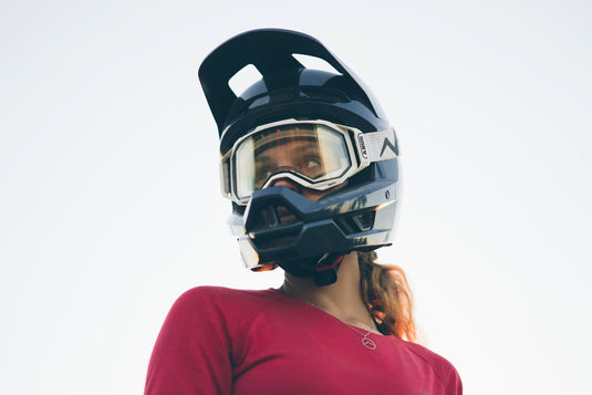 female cyclist on white background wearing ABUS HiDrop helmet and ABUS Buteo goggles.