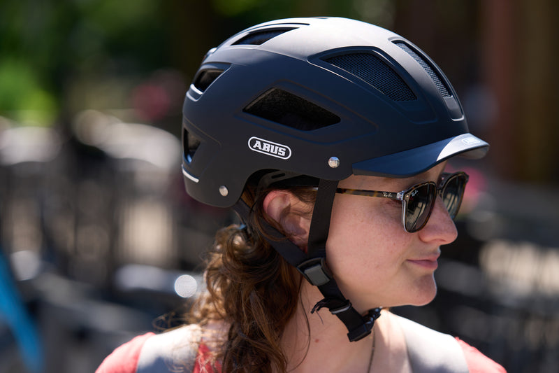 Load image into Gallery viewer, female cyclist wearing black Hyban 2.0 helmet
