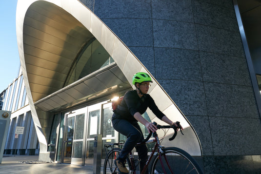 cyclist in urban environment wearing yellow Hyban 2.0 helmet