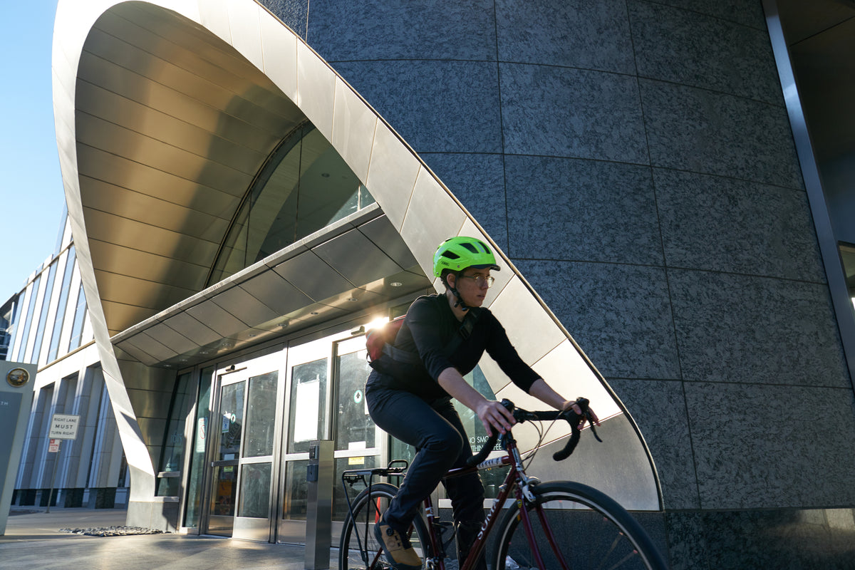 cyclist in urban environment wearing yellow Hyban 2.0 helmet