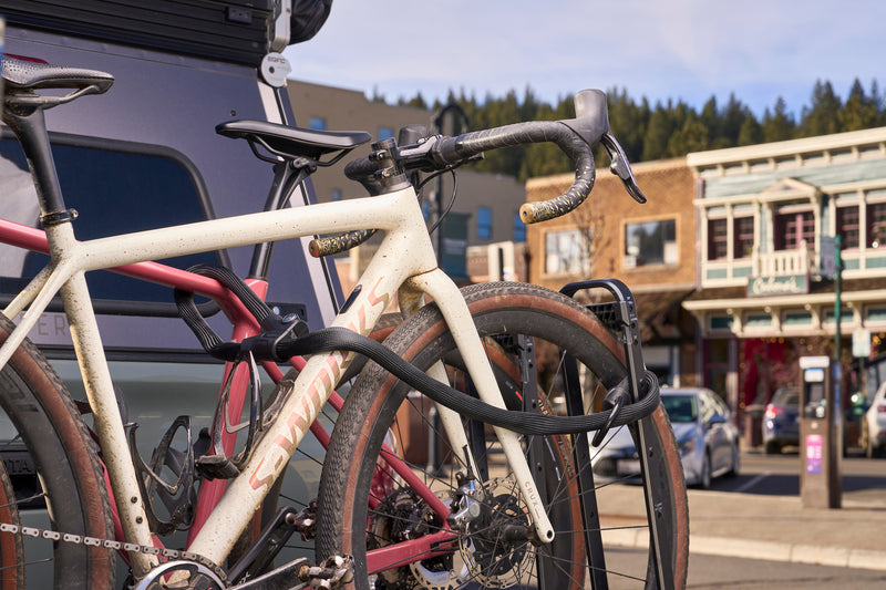 Load image into Gallery viewer, Infinity Loop 1806 securing two bicycles to hitch rack in downtown setting #color_black
