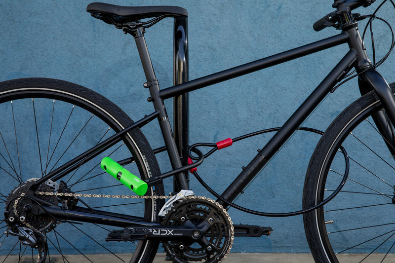 Load image into Gallery viewer, black bike locked to bike rack with 410 standard and cobra cable 
