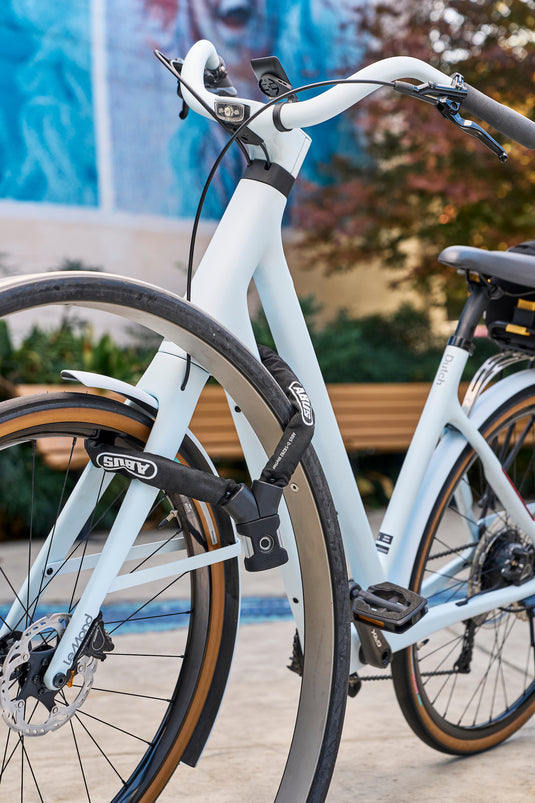 white bicycle sercured to bike rack with ABUS Yardo 7807F