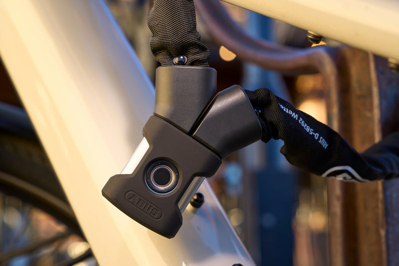 Load image into Gallery viewer, close-up of ABUS Yardo 7807F securing white bcycle
